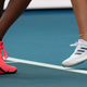 Tennis players Coco Gauff, left, and compatriot Caty McNally wear a tribute to Kobe Bryant on their shoes.